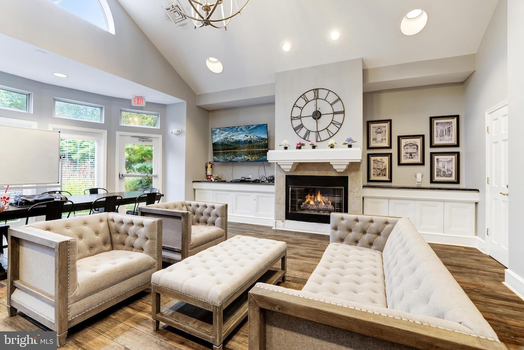 2204 Westcourt Ln Unit 122, Herndon, VA 20170 - living area with wood finished floors, a chandelier, recessed lighting, a tile fireplace, and high vaulted ceiling