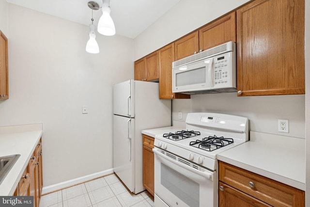 2204 Westcourt Ln Unit 122, Herndon, VA 20170 - kitchen with white appliances, brown cabinetry, baseboards, and light countertops