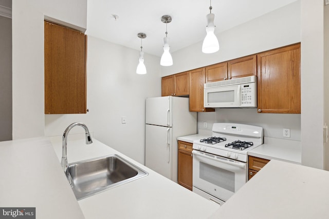 2204 Westcourt Ln Unit 122, Herndon, VA 20170 - kitchen with white appliances, a sink, brown cabinets, and hanging light fixtures