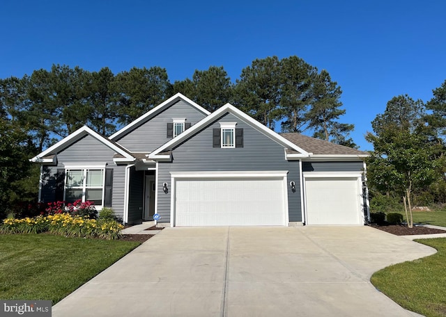 traditional-style house with concrete driveway, a front lawn, and an attached garage