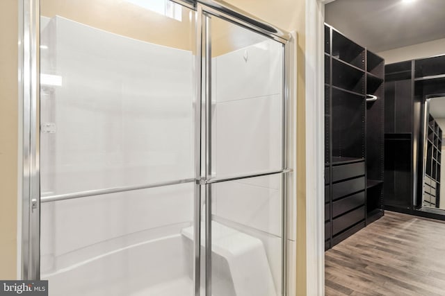 bathroom featuring a stall shower and wood finished floors