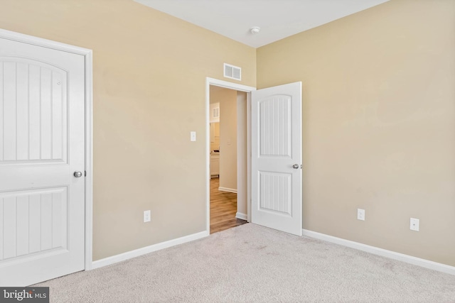 unfurnished bedroom with carpet and baseboards