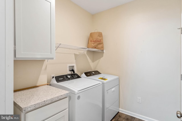 laundry room with separate washer and dryer, cabinet space, dark wood-style floors, and baseboards