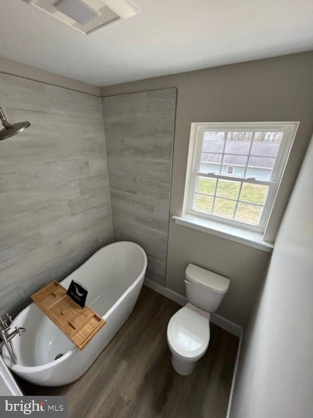 399REAR Beck Mill Rd, Hanover, PA 17331 - bathroom featuring wood finished floors, a freestanding tub, toilet, and tile walls