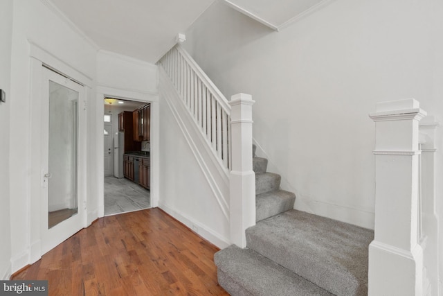 1609 E 33rd St, Baltimore, MD 21218 - stairway with wood finished floors, ornamental molding, and baseboards