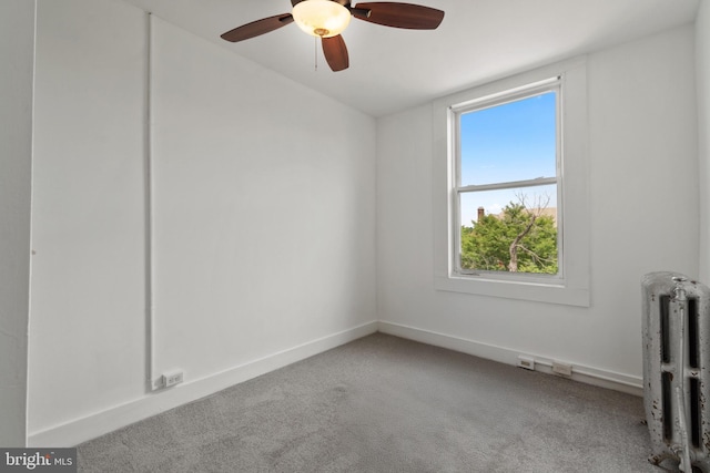 1609 E 33rd St, Baltimore, MD 21218 - spare room with radiator heating unit, carpet flooring, a ceiling fan, and baseboards