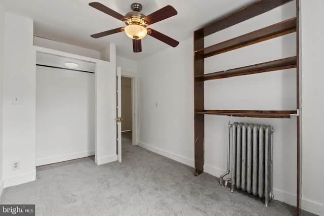 1609 E 33rd St, Baltimore, MD 21218 - unfurnished bedroom featuring radiator heating unit, a closet, carpet flooring, and baseboards
