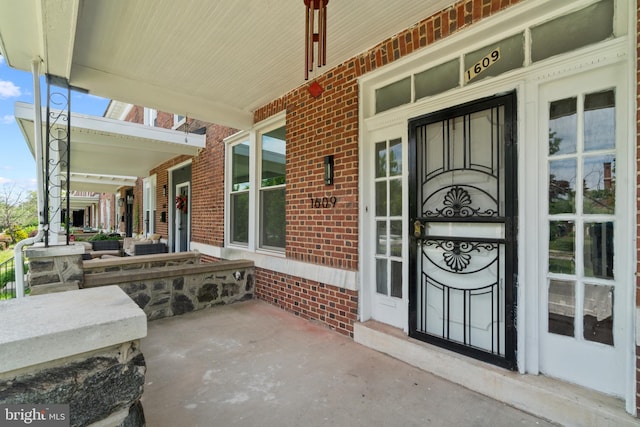 1609 E 33rd St, Baltimore, MD 21218 - property entrance with covered porch and brick siding