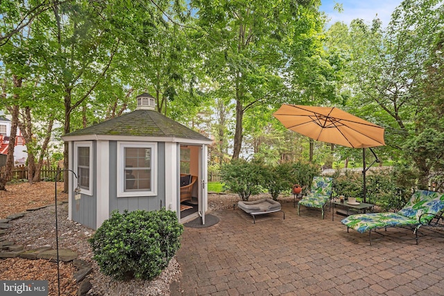 view of outdoor structure with fence and a gazebo