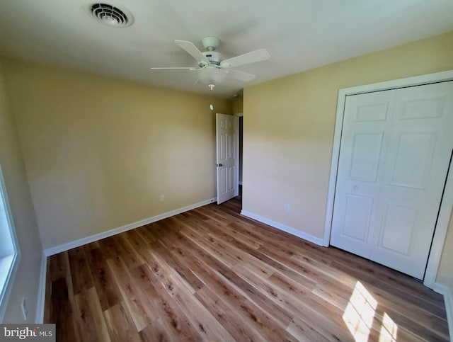 4302 Messick Rd, Rhodesdale, MD 21659 - unfurnished bedroom featuring wood finished floors, baseboards, a closet, and a ceiling fan
