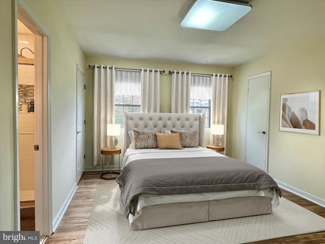 7972 Lakecrest Dr, Greenbelt, MD 20770 - bedroom featuring multiple windows, wood finished floors, and baseboards