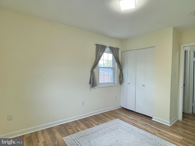7972 Lakecrest Dr, Greenbelt, MD 20770 - unfurnished bedroom with wood finished floors, baseboards, and a closet