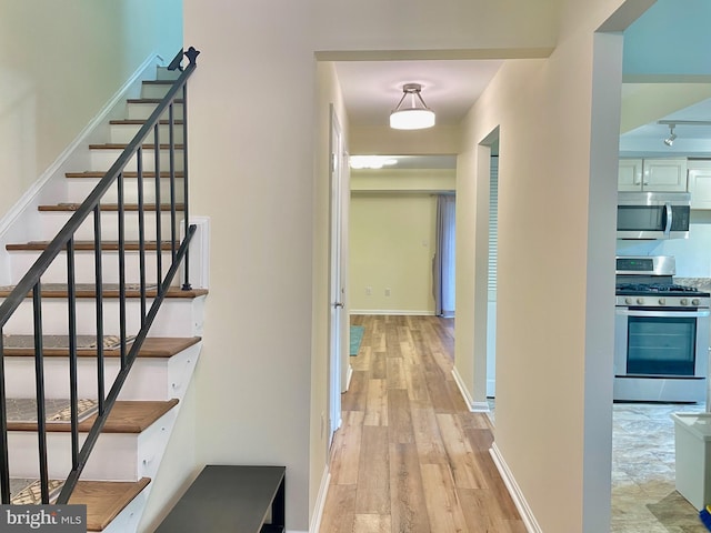 7972 Lakecrest Dr, Greenbelt, MD 20770 - hallway with light wood-style floors, stairs, and baseboards