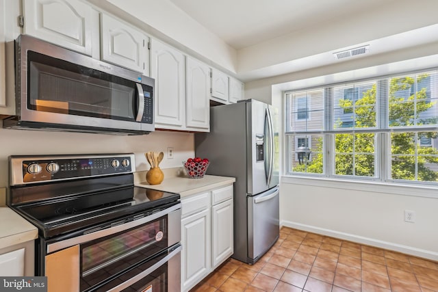 810 N Fayette St, Alexandria, VA 22314 - kitchen featuring appliances with stainless steel finishes, light countertops, white cabinets, and baseboards