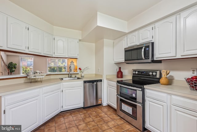 810 N Fayette St, Alexandria, VA 22314 - kitchen with appliances with stainless steel finishes, a sink, white cabinets, and light countertops