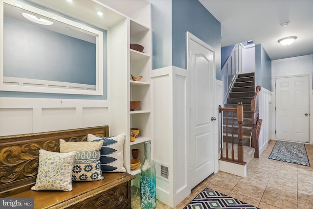 801 Skippers Ln, Annapolis, MD 21401 - entrance foyer with stairs, a decorative wall, and light tile patterned flooring