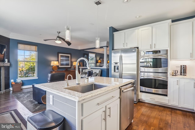 801 Skippers Ln, Annapolis, MD 21401 - kitchen featuring stainless steel appliances, a sink, ornamental molding, open floor plan, and dark wood-type flooring