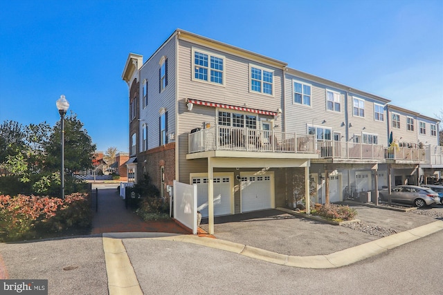 801 Skippers Ln, Annapolis, MD 21401 - back of property featuring asphalt driveway, a garage, a residential view, and a balcony