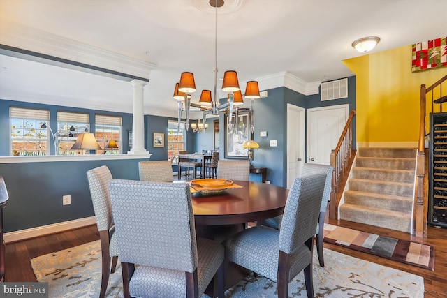 801 Skippers Ln, Annapolis, MD 21401 - dining space with decorative columns, stairs, a chandelier, wood finished floors, and baseboards