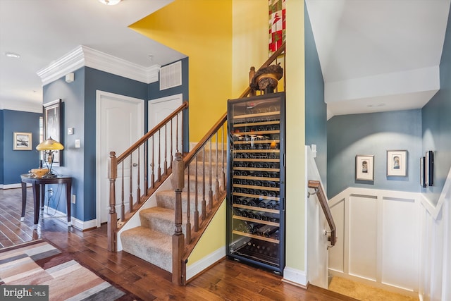 801 Skippers Ln, Annapolis, MD 21401 - staircase featuring wine cooler, wood finished floors, and crown molding