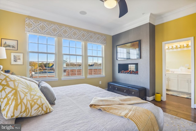 801 Skippers Ln, Annapolis, MD 21401 - bedroom with wood finished floors, crown molding, ensuite bath, a ceiling fan, and baseboards