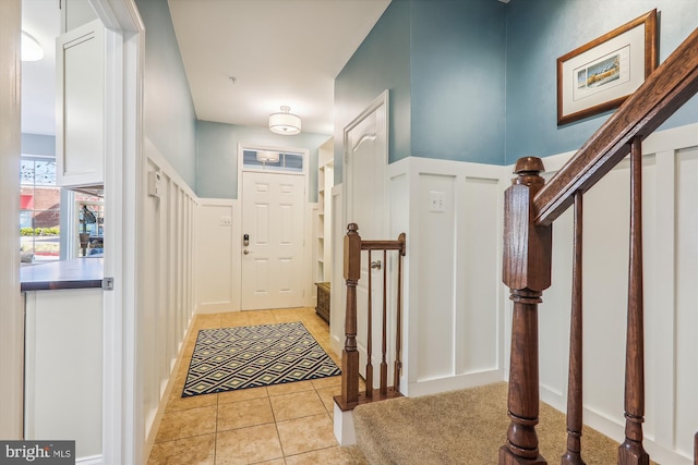 801 Skippers Ln, Annapolis, MD 21401 - entryway with light tile patterned floors, stairway, and a decorative wall