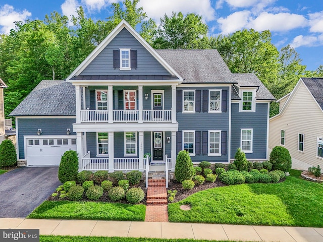 greek revival inspired property with covered porch, asphalt driveway, a garage, a standing seam roof, and a shingled roof
