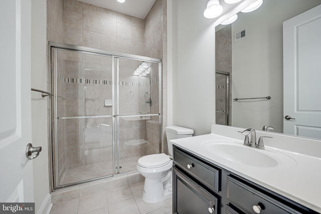 bathroom featuring toilet, a shower stall, tile patterned floors, and vanity