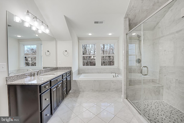 bathroom featuring a garden tub, vanity, a stall shower, and tile patterned flooring