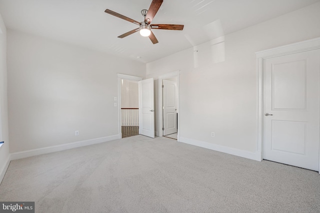 unfurnished bedroom featuring carpet floors, baseboards, and a ceiling fan