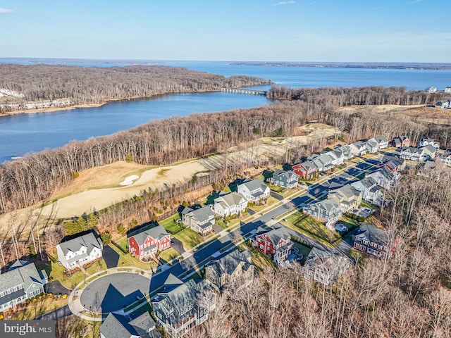 aerial view of residential area featuring a large body of water and a golf course