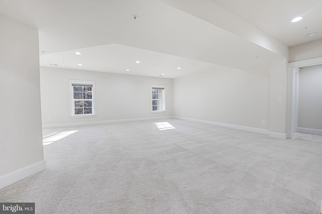 empty room with light colored carpet, recessed lighting, baseboards, and fire sprinkler in ceiling
