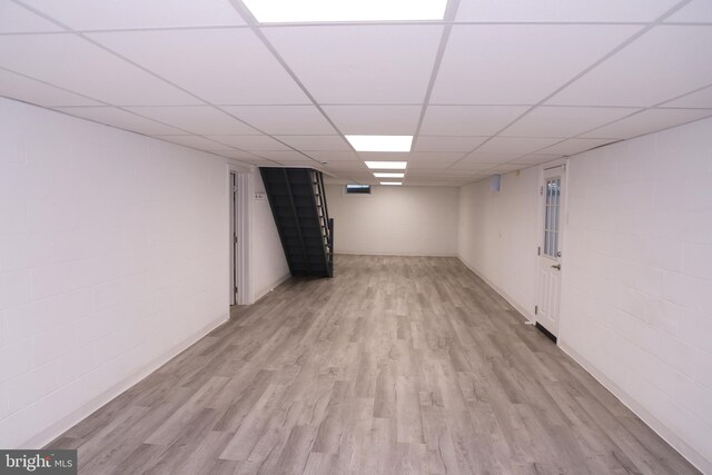 13209 Briarcliff Dr, Hagerstown, MD 21742 - finished below grade area featuring light wood-style floors, a paneled ceiling, stairs, and concrete block wall