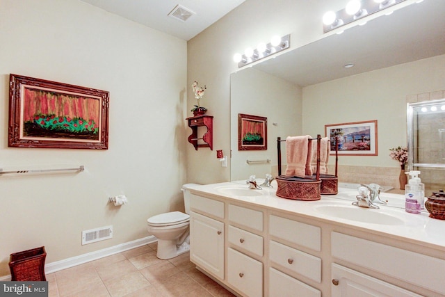 bathroom featuring tile patterned floors, toilet, double vanity, and baseboards