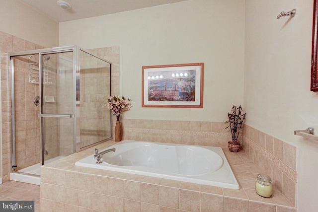 full bath with a stall shower and a garden tub