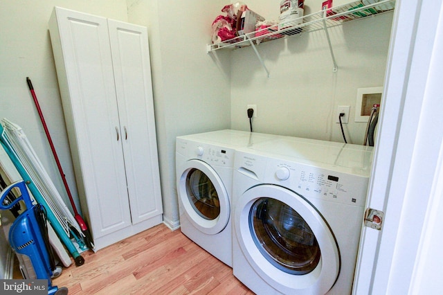 laundry area featuring washer and dryer and light wood-type flooring