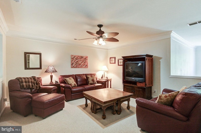 carpeted living room featuring crown molding and a ceiling fan