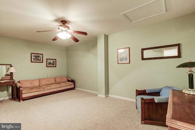 living area with carpet, attic access, ceiling fan, and baseboards