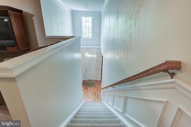 stairs featuring crown molding