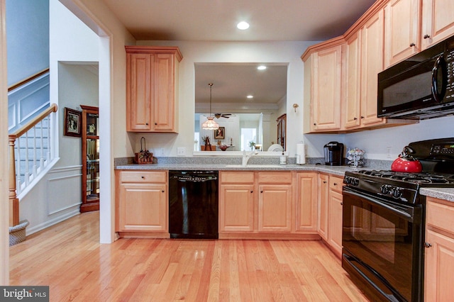 kitchen featuring black appliances, light brown cabinetry, light wood-type flooring, and recessed lighting