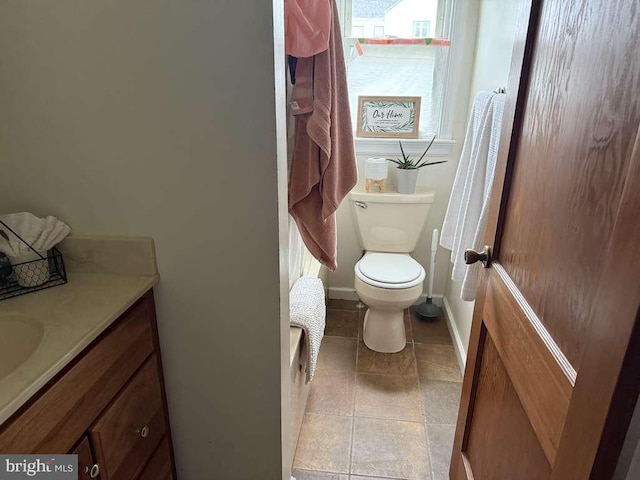 full bath featuring tile patterned floors, toilet, vanity, and baseboards