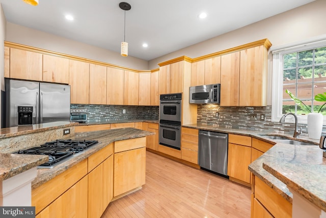 12406 Old Grey Mare Ct, Reisterstown, MD 21136 - kitchen with stainless steel appliances, a sink, light brown cabinetry, light stone counters, and light wood finished floors