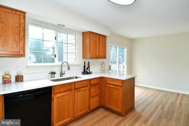 43193 Ribboncrest Ter, Ashburn, VA 20147 - kitchen featuring black dishwasher, light wood-type flooring, a peninsula, and brown cabinets