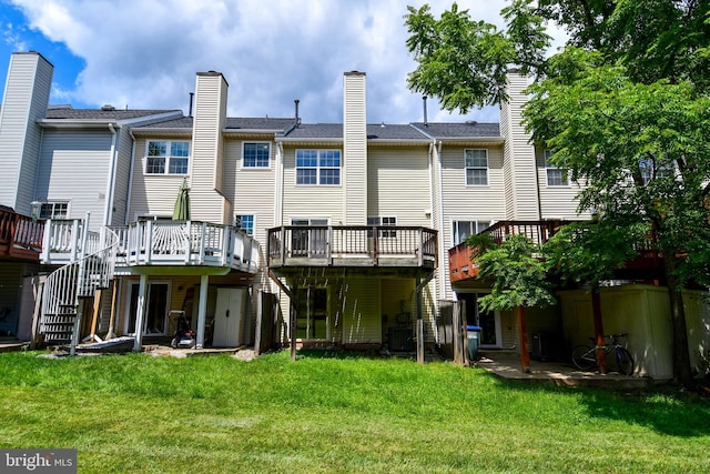 43193 Ribboncrest Ter, Ashburn, VA 20147 - back of property featuring stairway, a wooden deck, and a lawn