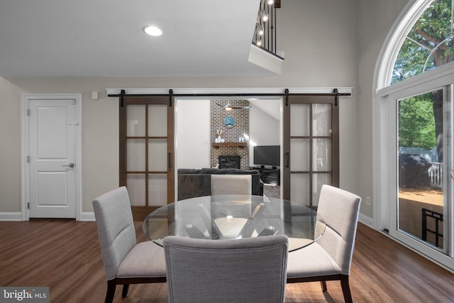 410 Metropolitan Blvd, Pasadena, MD 21122 - dining room featuring a barn door, dark wood-style flooring, baseboards, and recessed lighting