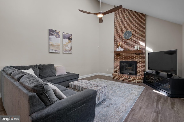 410 Metropolitan Blvd, Pasadena, MD 21122 - living area with high vaulted ceiling, a ceiling fan, wood finished floors, a brick fireplace, and baseboards