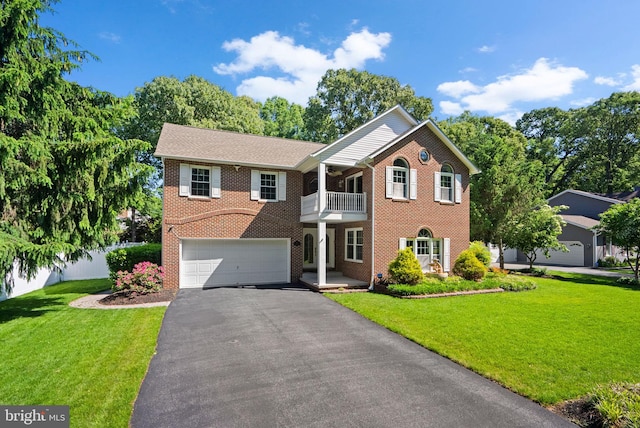 410 Metropolitan Blvd, Pasadena, MD 21122 - colonial home featuring a balcony, driveway, a garage, and brick siding
