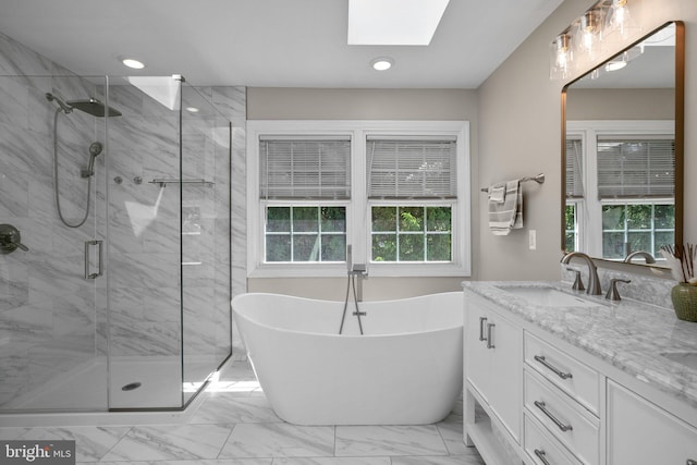 410 Metropolitan Blvd, Pasadena, MD 21122 - full bathroom featuring marble look tiles, a skylight, a marble finish shower, a freestanding bath, and vanity