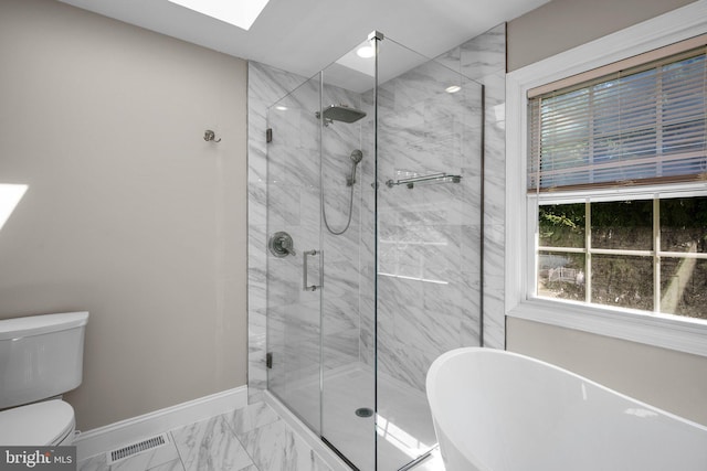 410 Metropolitan Blvd, Pasadena, MD 21122 - full bathroom featuring marble finish floors, baseboards, a skylight, a freestanding bath, and a stall shower
