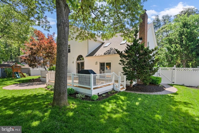 410 Metropolitan Blvd, Pasadena, MD 21122 - back of property featuring a gate, a wooden deck, a playground, a chimney, and roof with shingles